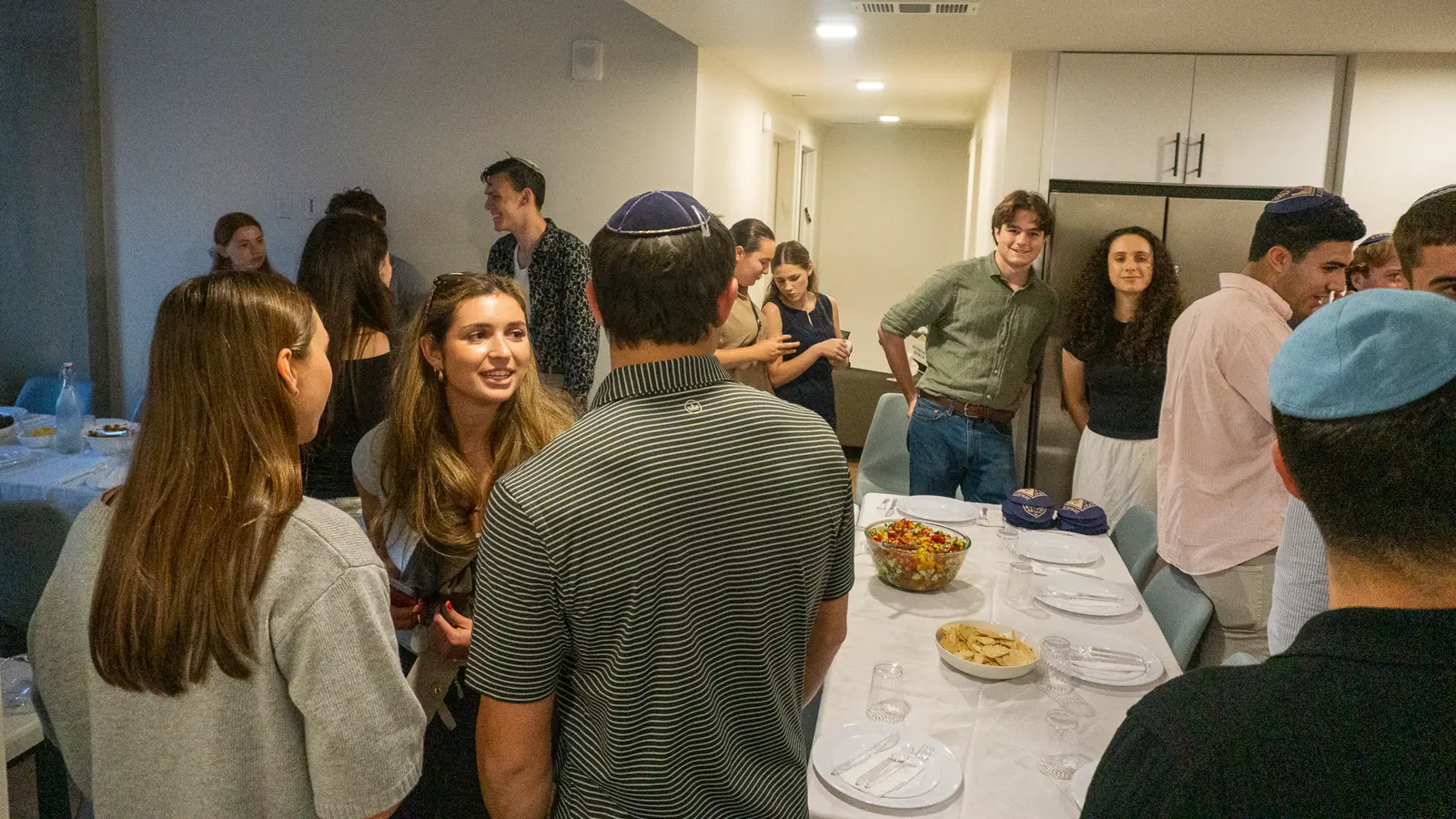 A full room of guests before kiddush